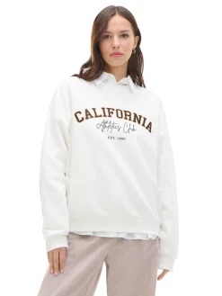 Kremowa bluza z naszywkami